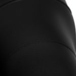 Close-up of black shiny leggings high waisted yoga pants, showcasing moisture-wicking performance fabric texture and stitching.
