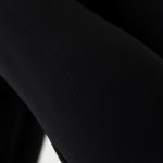 Close-up of black yoga pants fabric showing moisture-wicking performance material and quality stitching for straight leg yoga pants.