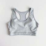 Heather Grey cropped gym top, active wear crop top folded neatly in flat lay on a clean neutral surface.
