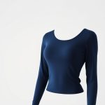 Navy Blue long sleeve yoga tops seamless tops on white background, hyperrealistic studio photo.