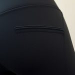Close-up of eco-friendly black cycling shorts with pockets, highlighting fabric texture and stitching detail.