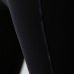 Close-up of black wide leg yoga pants scrunch legging fabric showing texture, stitching, and premium material quality.
