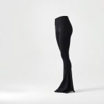 Black yoga pants flare from Luna on a clean white studio background.