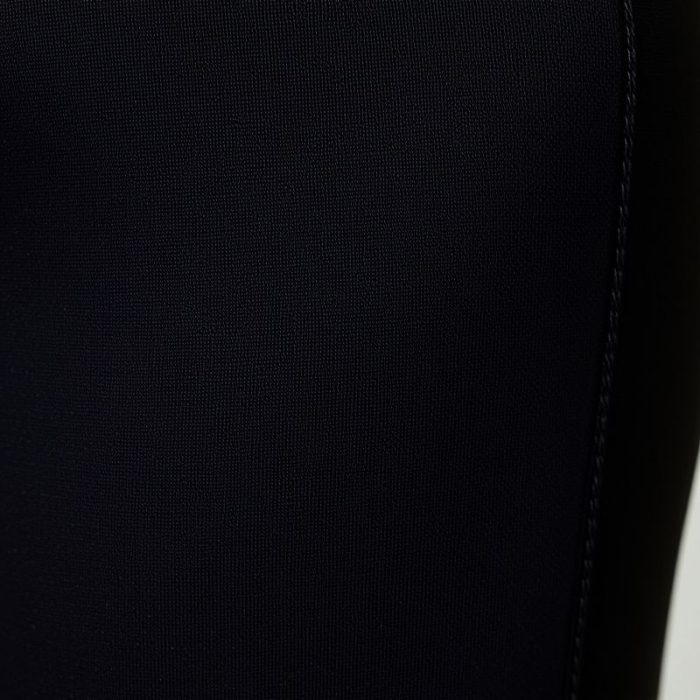 Close-up of black yoga pants flare fabric showing moisture-wicking texture and quality stitching.