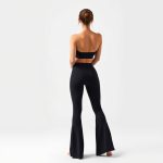 Back view of a model wearing the black yoga pants flare where to buy luna, showcasing the fit from behind.