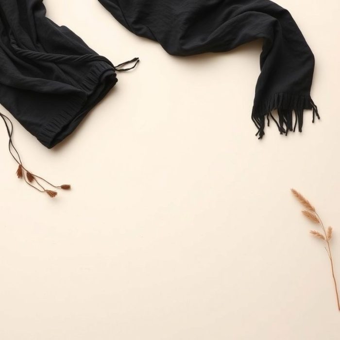 Flat lay of the boho clothing brand chai loose leaf top in black, neatly folded on a neutral surface.