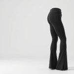 Flare black yoga pants with pockets, charcoal active leggings on white background, hyperrealistic studio photo.
