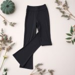 Flat lay of charcoal petite flare leggings Australia neatly folded on a neutral surface.