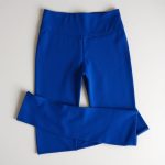 Royal Blue high waist leggings with pockets, neatly folded on a neutral surface, flat lay top-down view.