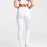 A model wearing high waist leggings workout leggings with pockets in white, back view, studio shot.