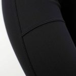 Close-up of the textured fabric and stitching on high waisted flare leggings with pockets, showcasing material quality.