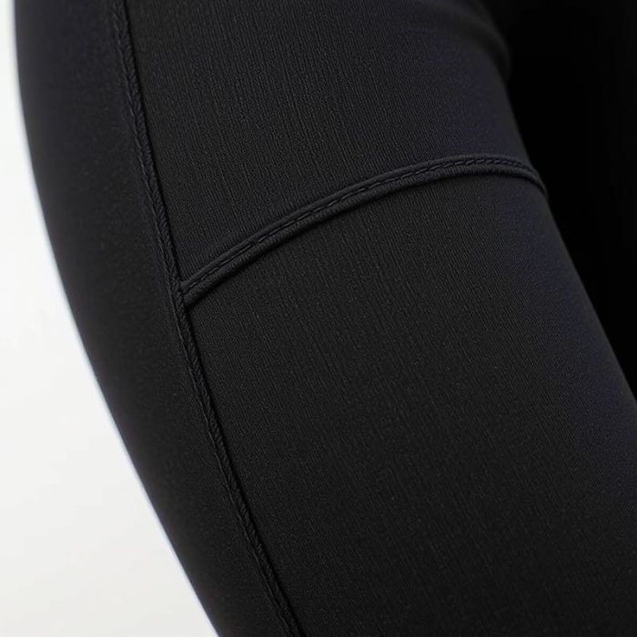 Close-up of the textured fabric and stitching on high waisted flare leggings with pockets, showcasing material quality.