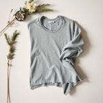 Heather Grey boho poncho from leggings australia online, folded flat on a neutral surface.