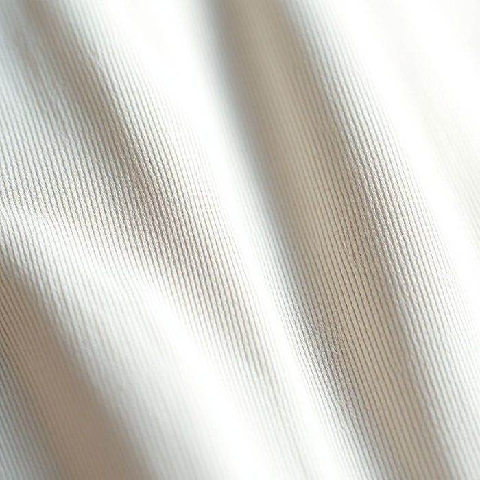 Close-up detail of the sustainable activewear australia organic cotton yoga pants fabric texture and stitching.