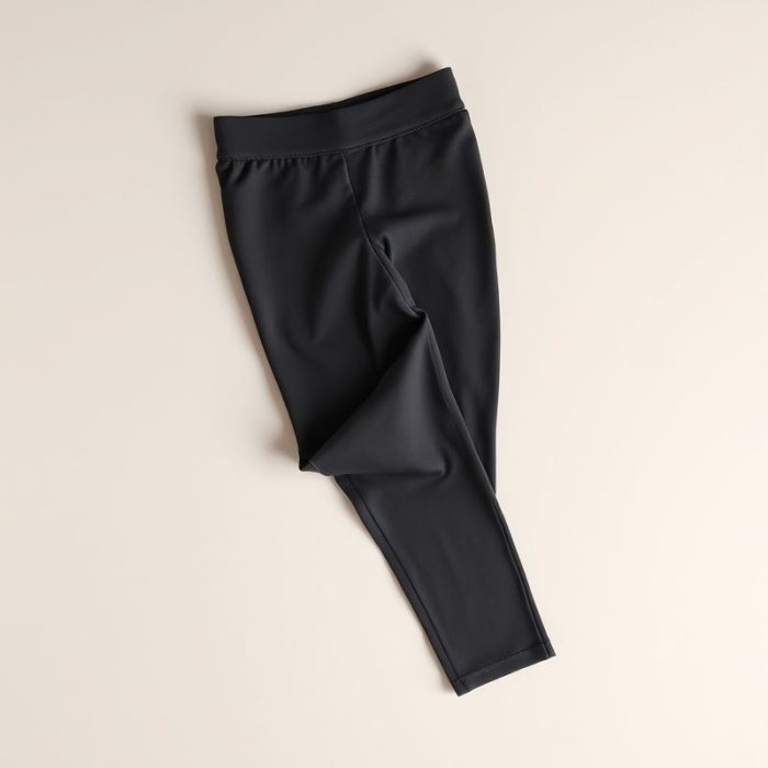 Organic cotton yoga pants in Charcoal, sustainable activewear folded flat lay.