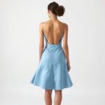 Back view of a model wearing the Sky Blue rose skirt byron bay cacao on a white background.