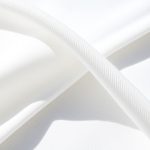 Close-up of the white yoga top fabric, made from Lenzing Ecovero and Pima Cotton, showing texture and stitching.
