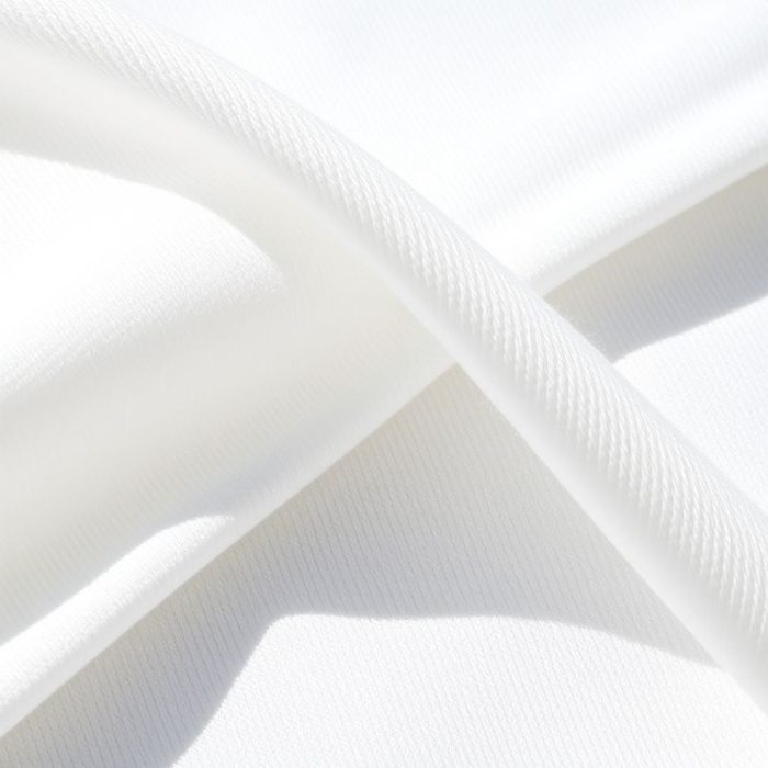 Close-up of the white yoga top fabric, made from Lenzing Ecovero and Pima Cotton, showing texture and stitching.