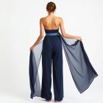 Back view of Navy Blue wide leg yoga pants made from bamboo, on a model with a white studio background.