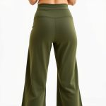 Back view of olive green wide leg yoga pants flare on model, studio shot with white background.