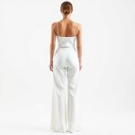 Back view of a model wearing wide leg yoga pants Australia flare black yoga pants in white, studio shot.