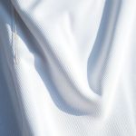 Close-up of women's golf pants fabric, showcasing polyester-cotton blend texture and quality stitching for golf clothes women Australia.