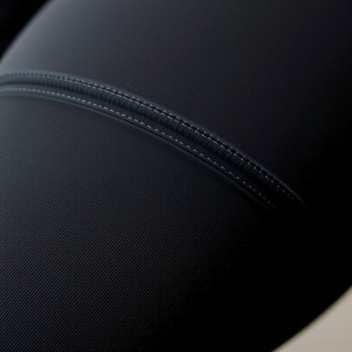 Close-up of black seamless womens leggings pockets, highlighting recycled fabric texture and quality stitching.