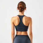 Back view of a model wearing womens yoga shirts yoga bras in Charcoal, showcasing fit on white studio background.
