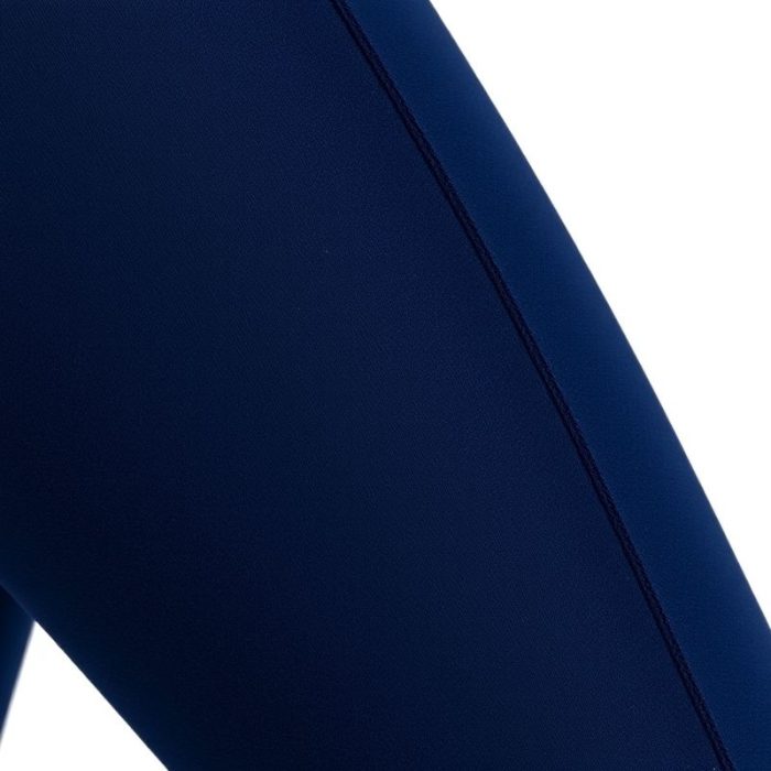 Close-up of the navy flared yoga crop fabric texture and stitching detail.