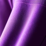 Close-up of the soft cashmere blend fabric on our purple yoga crop pants.