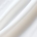Close-up of the soft organic cotton fabric and stitching on a yoga long sleeve top.
