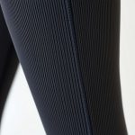 Close-up of ribbed flared leggings fabric showing texture and stitching for yoga pants flare.