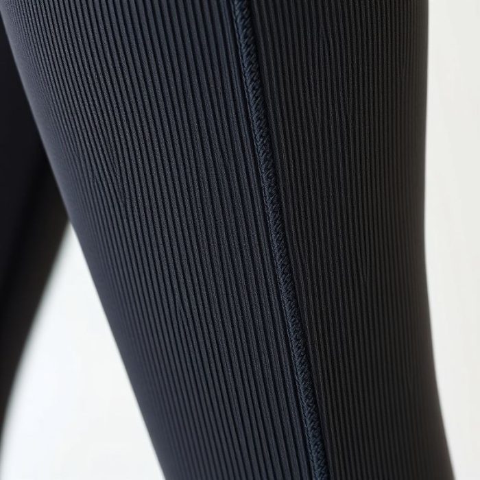 Close-up of ribbed flared leggings fabric showing texture and stitching for yoga pants flare.