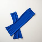 Royal Blue ribbed flared leggings folded neatly on a neutral surface, yoga pants flare style.