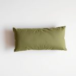 Flat lay of an olive green yoga pillow bolster neatly folded on a neutral surface, minimalist e-commerce style.