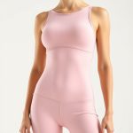 Pastel pink yoga suit made with Lenzing Ecovero on a white background.