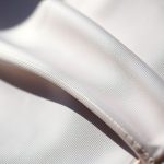 Close-up macro shot of the sustainable Lenzing Ecovero yoga suit fabric texture and stitching.