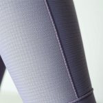 Close-up detail of the yoga tank flared tights fabric texture and stitching.