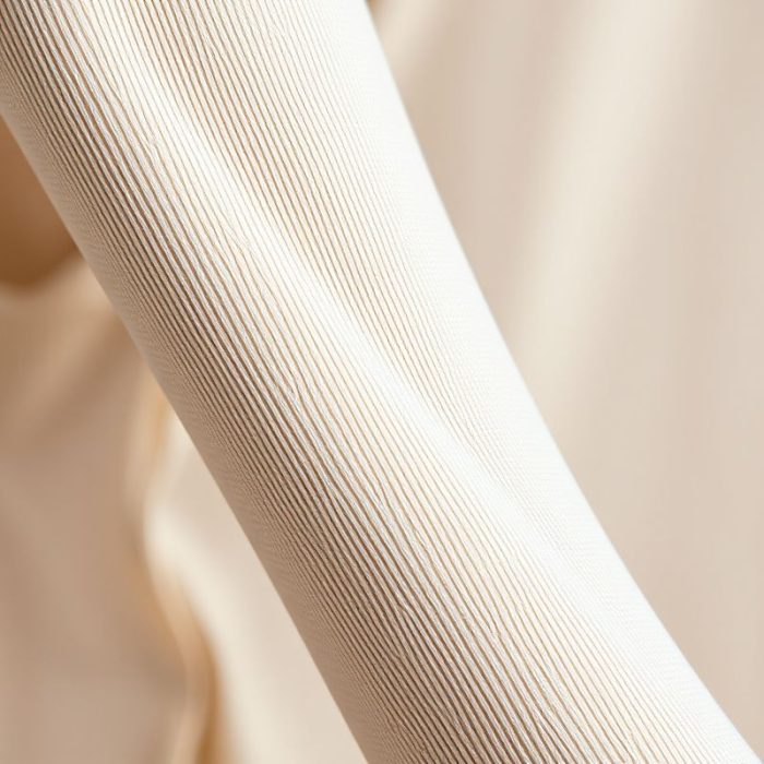 Close-up detail of the soft, sustainable Econyl fabric on a long sleeve yoga top, showing quality stitching.
